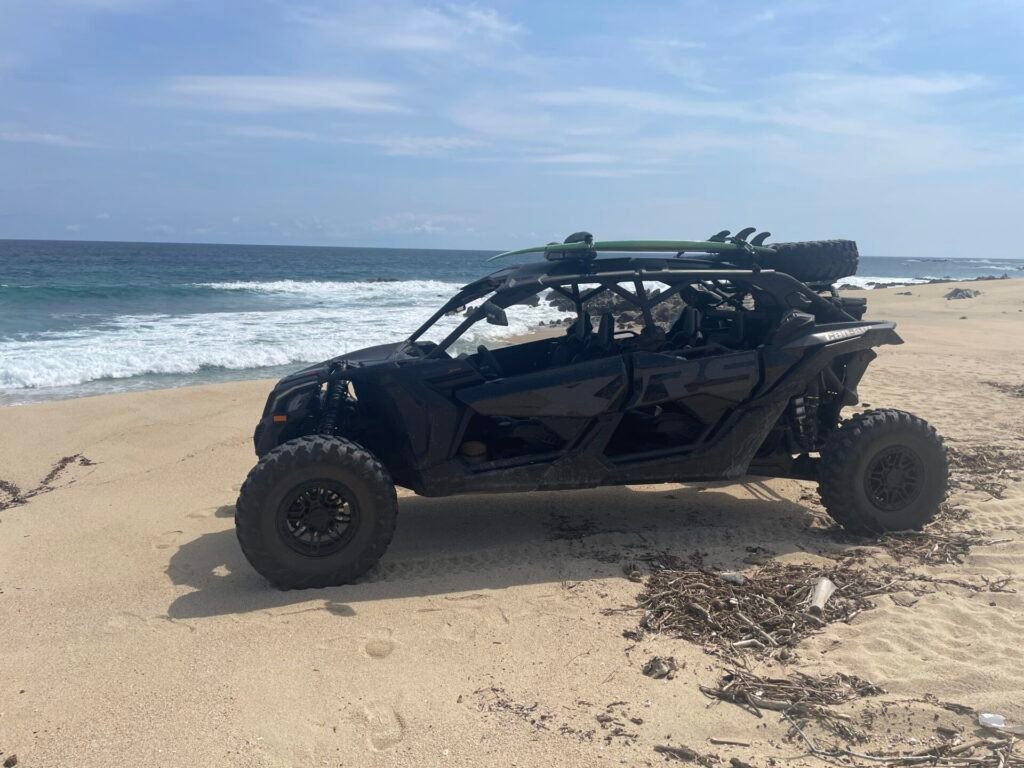 Can-Am Maverick X3 parked at Acre Restaurant with guests loading for a VIP transfer to Flora Farms, San José del Cabo